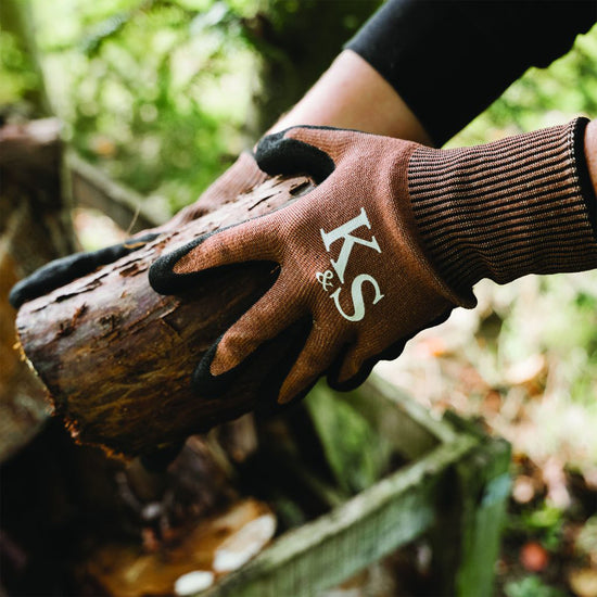 Kent & Stowe Sure & Grip All Purpose Gloves holding log