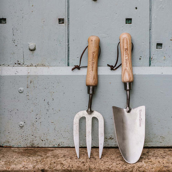 Kent & Stowe Stainless Steel Hand Trowel next to hand fork