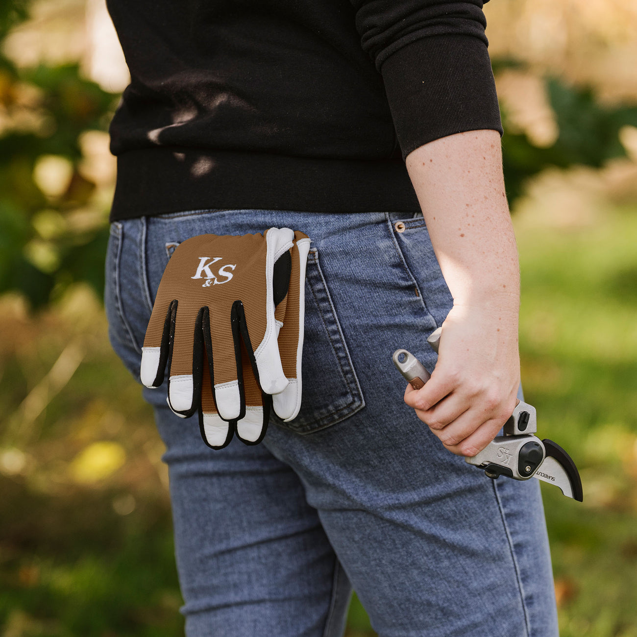 Kent & Stowe Sure & Fit Multi Job Gloves in back pocket of woman