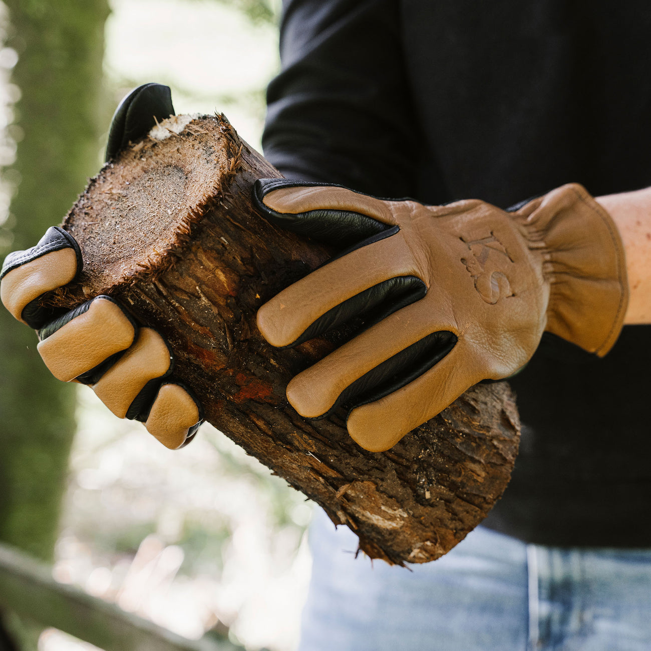woman wearing gloves holding tree stump